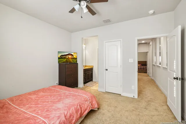 a bedroom with a bed and ceiling fan
