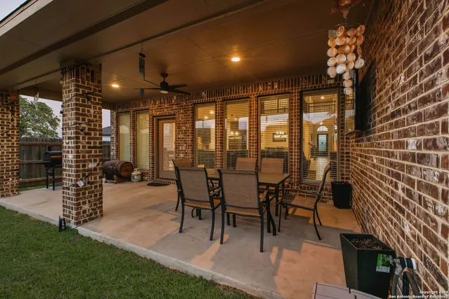 a view of a porch with chairs and backyard
