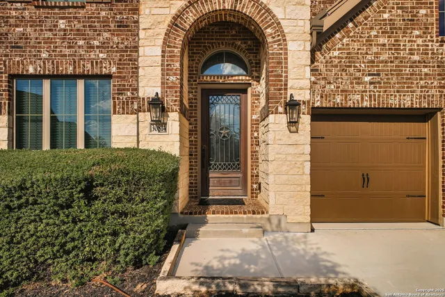 a view of a brick house with potted plants