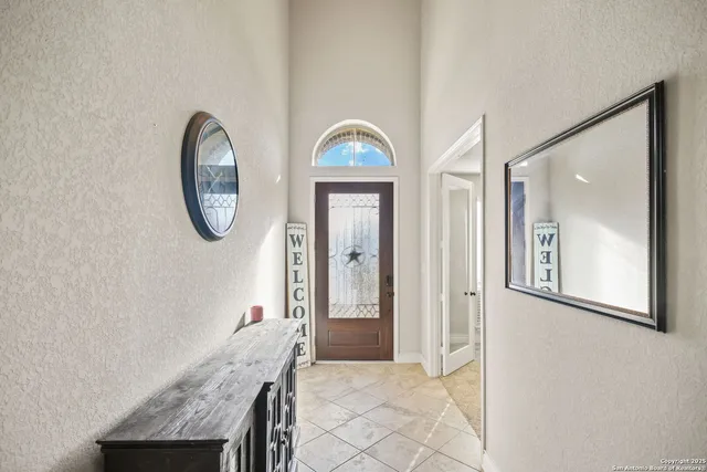 an entryway with wooden floor mirror and a wooden floor