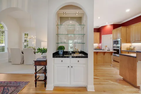 a kitchen with stainless steel appliances kitchen island granite countertop a stove a sink and a cabinets