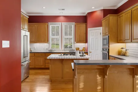 a kitchen with a sink stove and cabinets
