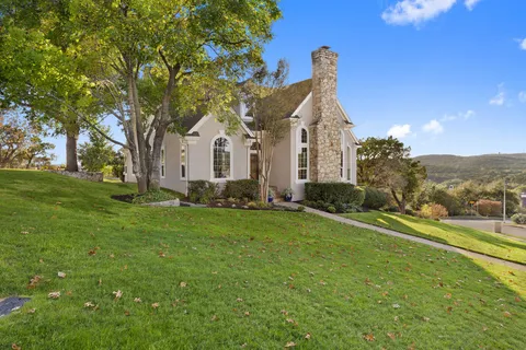 a front view of a house with garden