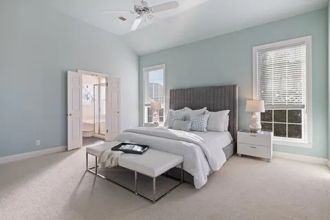 a spacious bedroom with a bed and a window