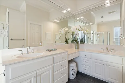 a bathroom with a double vanity sink mirror and double