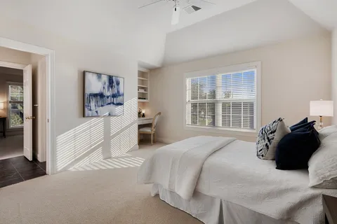 a bed room with a bed and a large window