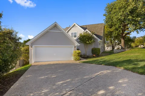 a view of a house with a yard and garage