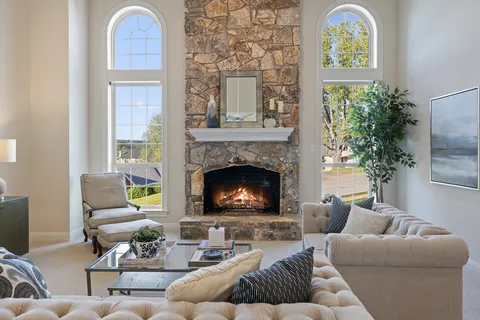 a living room with furniture fireplace and window