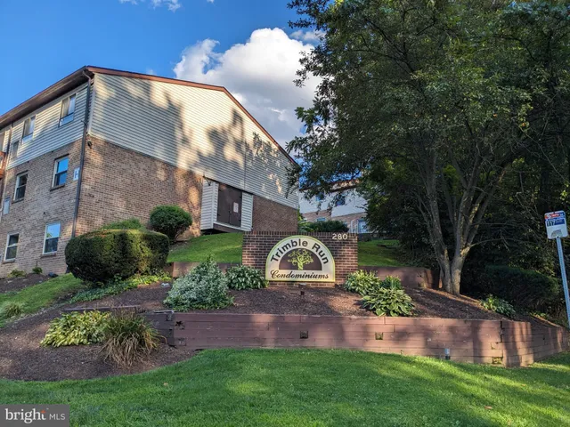 a view of a house with a yard and pathway