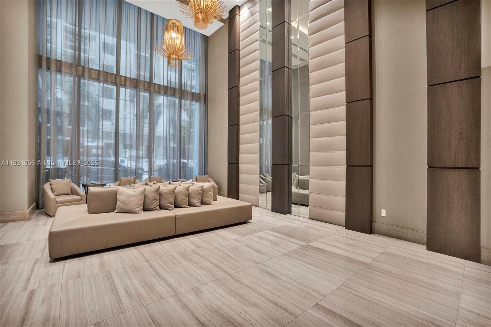 1010 Southwest 2nd Avenue, Unit 1004 Miami, FL 33130 - Photo 42 of 45 a bedroom with a bed and a couch next to a window