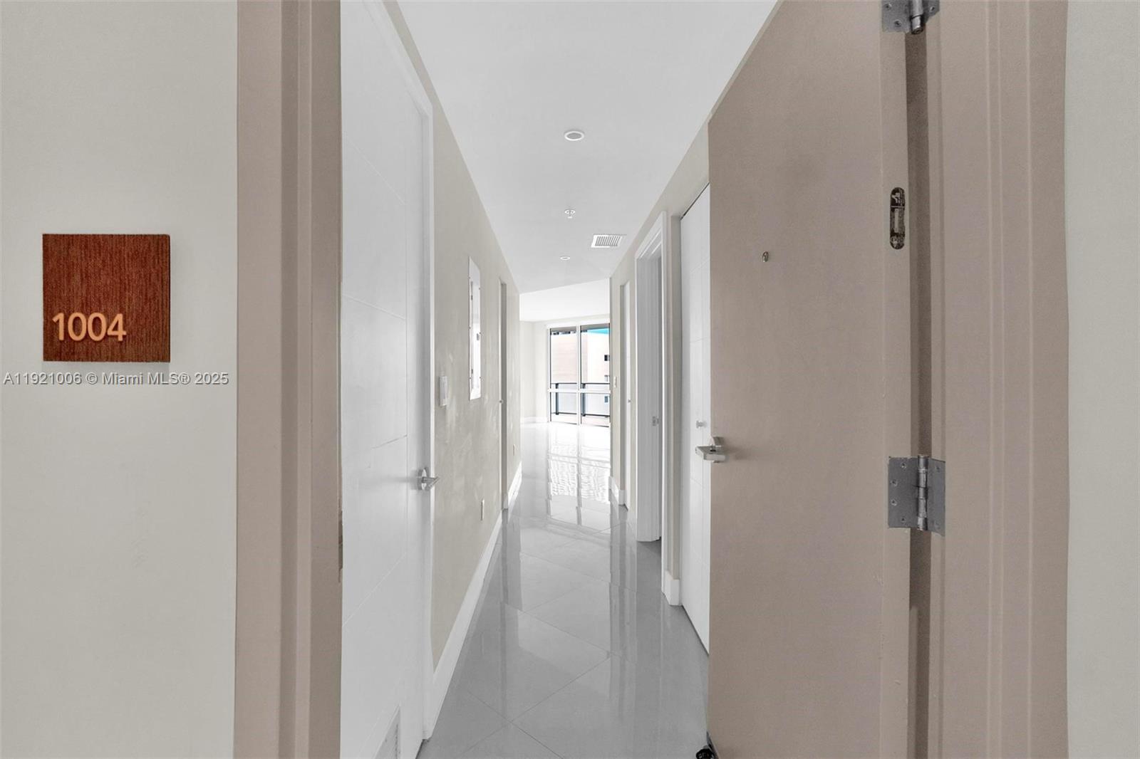 1010 Southwest 2nd Avenue, Unit 1004 Miami, FL 33130 - Photo 7 of 45 a view of a hallway with wooden floor and closet