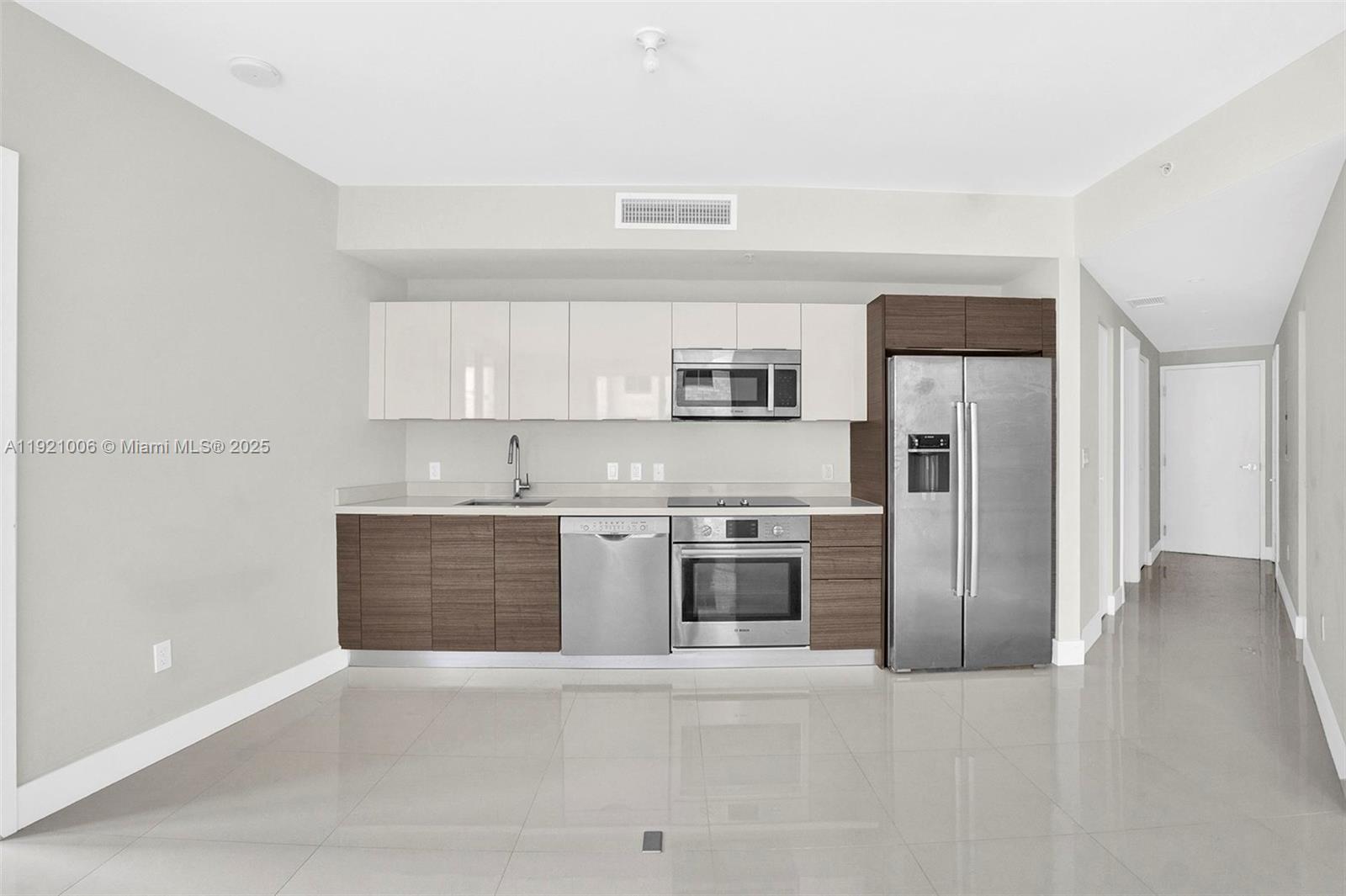 1010 Southwest 2nd Avenue, Unit 1004 Miami, FL 33130 - Photo 8 of 45 a large kitchen with cabinets stainless steel appliances and a counter space