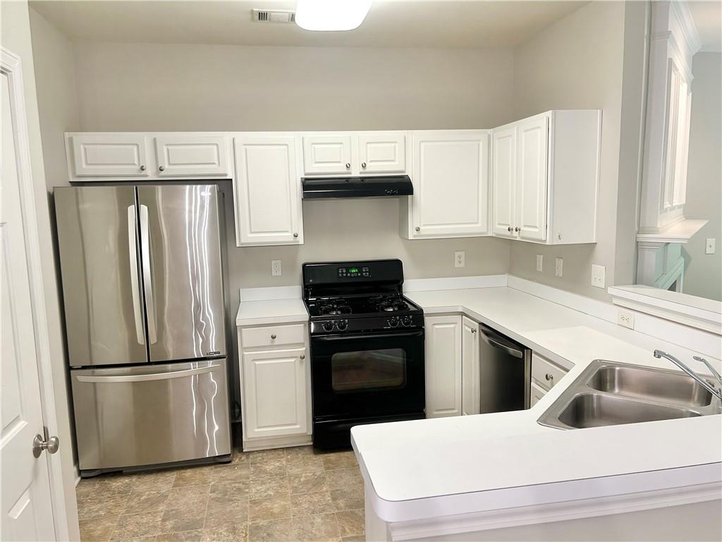3647 Postwaite Circle Northwest Duluth, GA 30097 - Photo 4 of 20 a kitchen with a refrigerator sink and stove