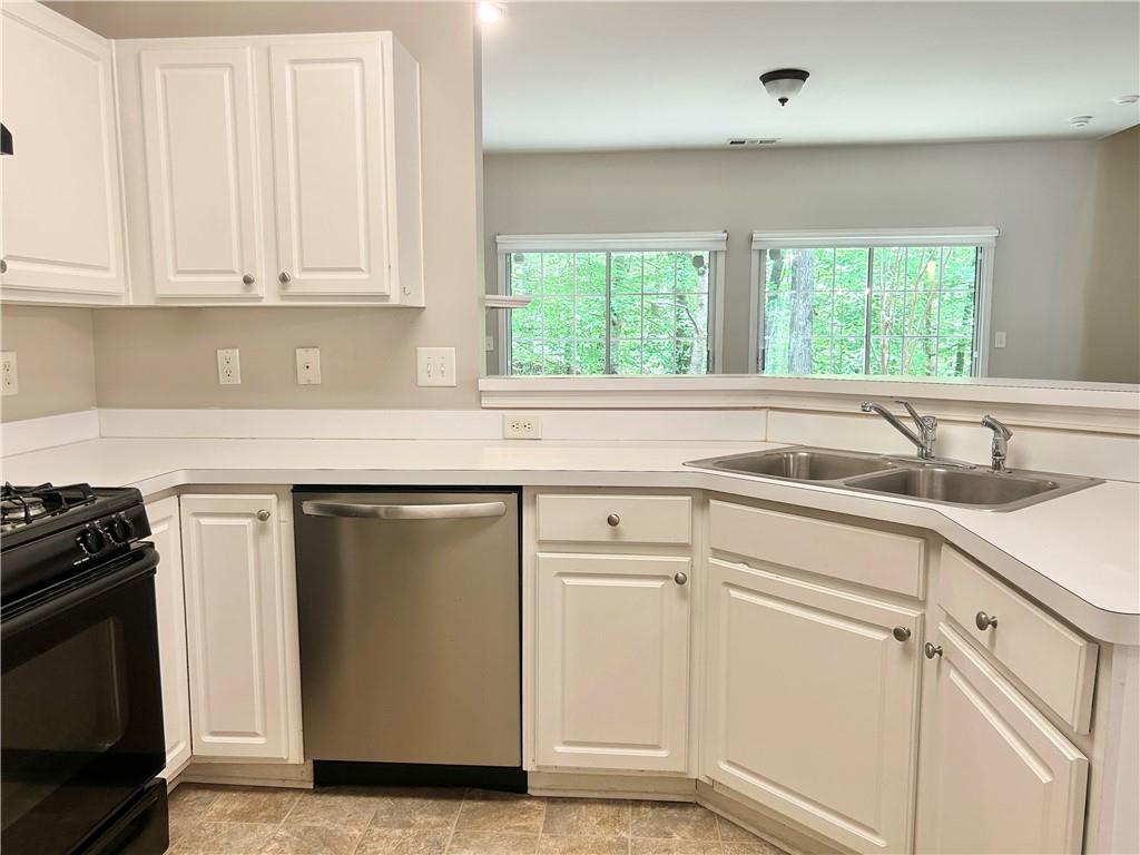 3647 Postwaite Circle Northwest Duluth, GA 30097 - Photo 5 of 20 a kitchen with white cabinets and a sink