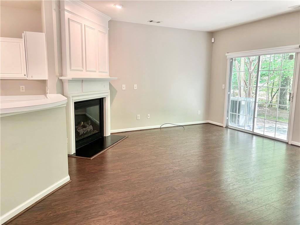 3647 Postwaite Circle Northwest Duluth, GA 30097 - Photo 6 of 20 a view of empty room with wooden floor and fireplace