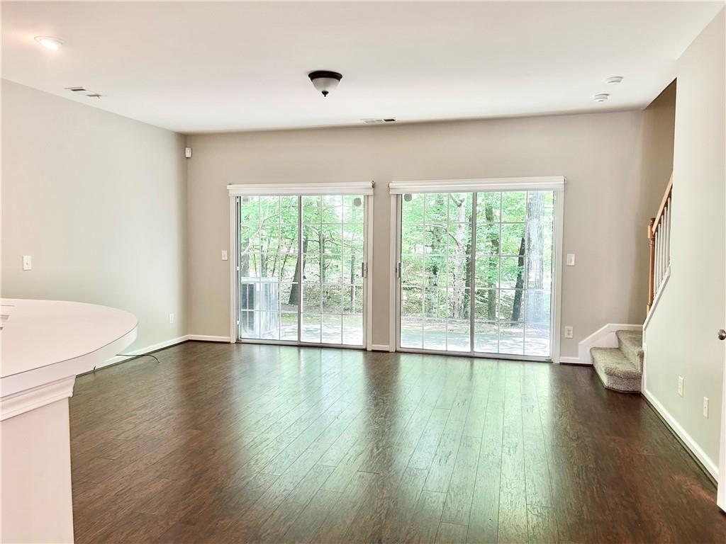 3647 Postwaite Circle Northwest Duluth, GA 30097 - Photo 7 of 20 a view of an empty room with wooden floor and a window