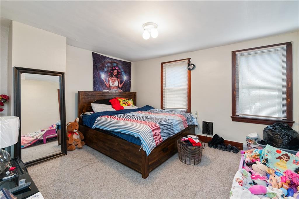 1412 4th Avenue Coraopolis, PA 15108 - Photo 9 of 14 a bedroom with a bed and a window