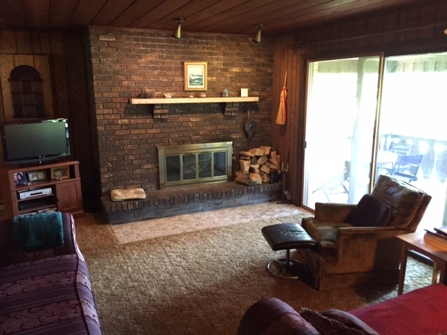 6615 Kemman Road Hebron, IL 60034 - Photo 14 of 25 a living room with furniture a flat screen tv and a fireplace