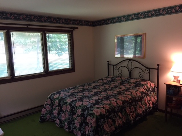 6615 Kemman Road Hebron, IL 60034 - Photo 17 of 25 a bedroom with a bed next to a window