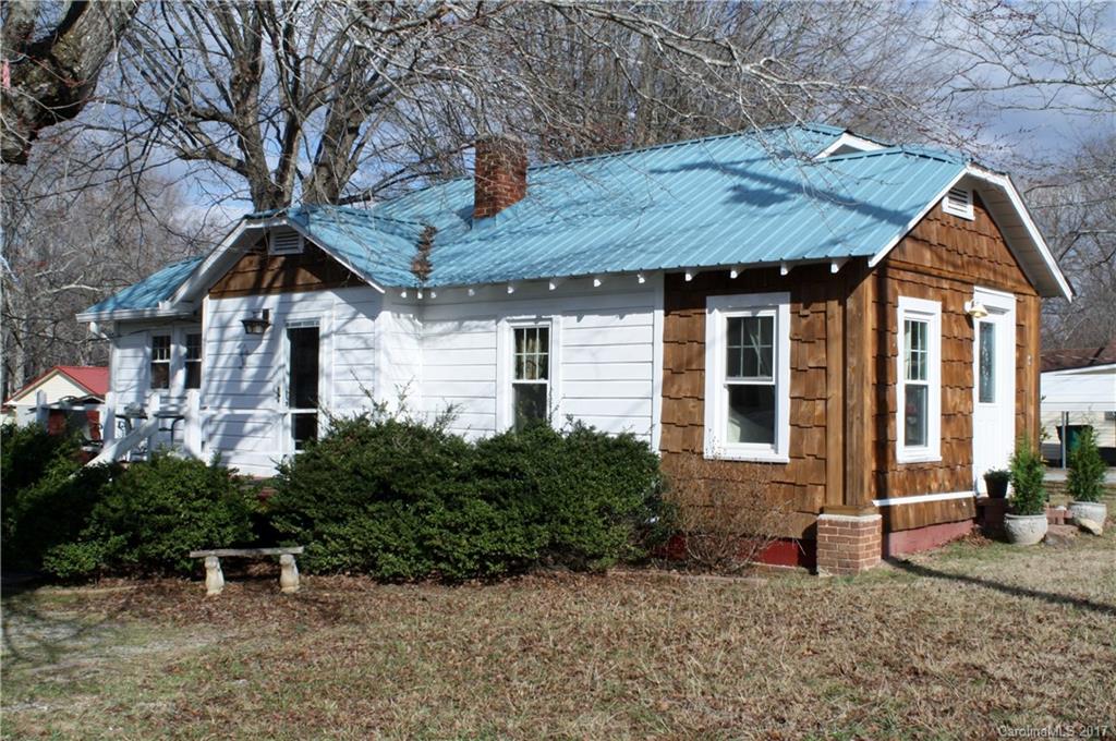 1460 Needmore Road Woodleaf, NC 27054 - Photo 1 of 16 a front view of a house with garden