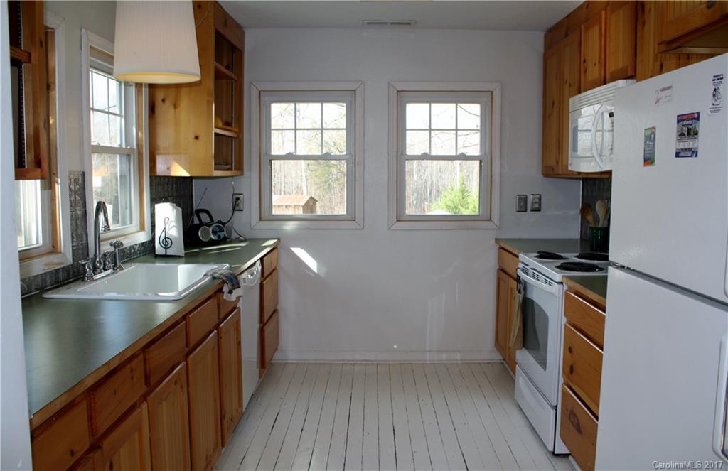 1460 Needmore Road Woodleaf, NC 27054 - Photo 2 of 16 a kitchen with stainless steel appliances granite countertop a sink stove and refrigerator