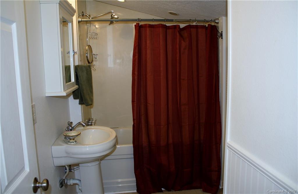 1460 Needmore Road Woodleaf, NC 27054 - Photo 5 of 16 a bathroom with a sink and a mirror