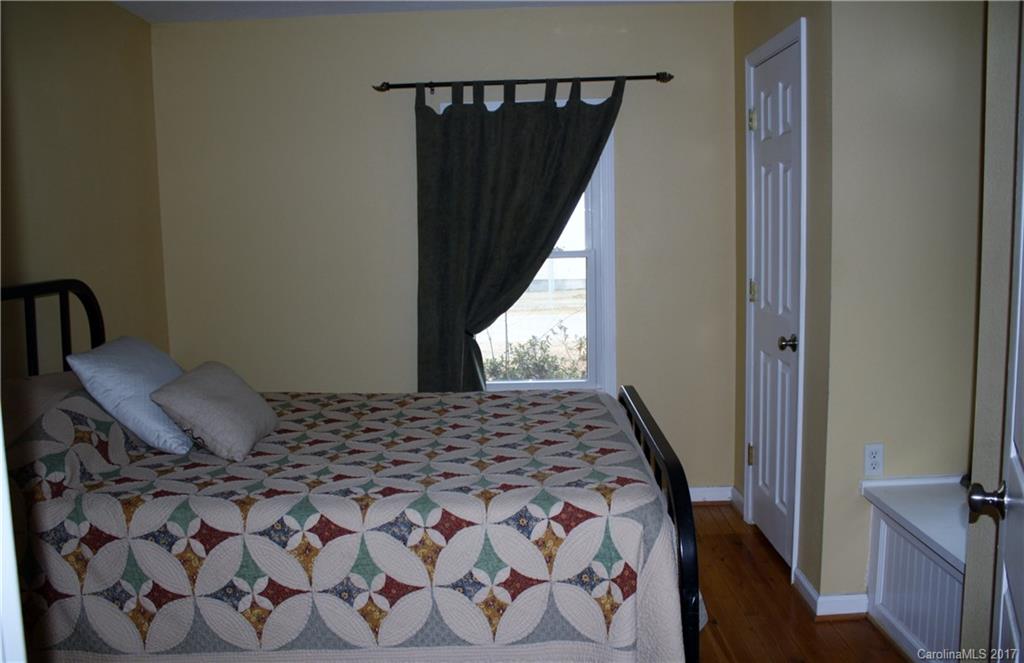 1460 Needmore Road Woodleaf, NC 27054 - Photo 9 of 16 a bedroom with a bed and wooden floor