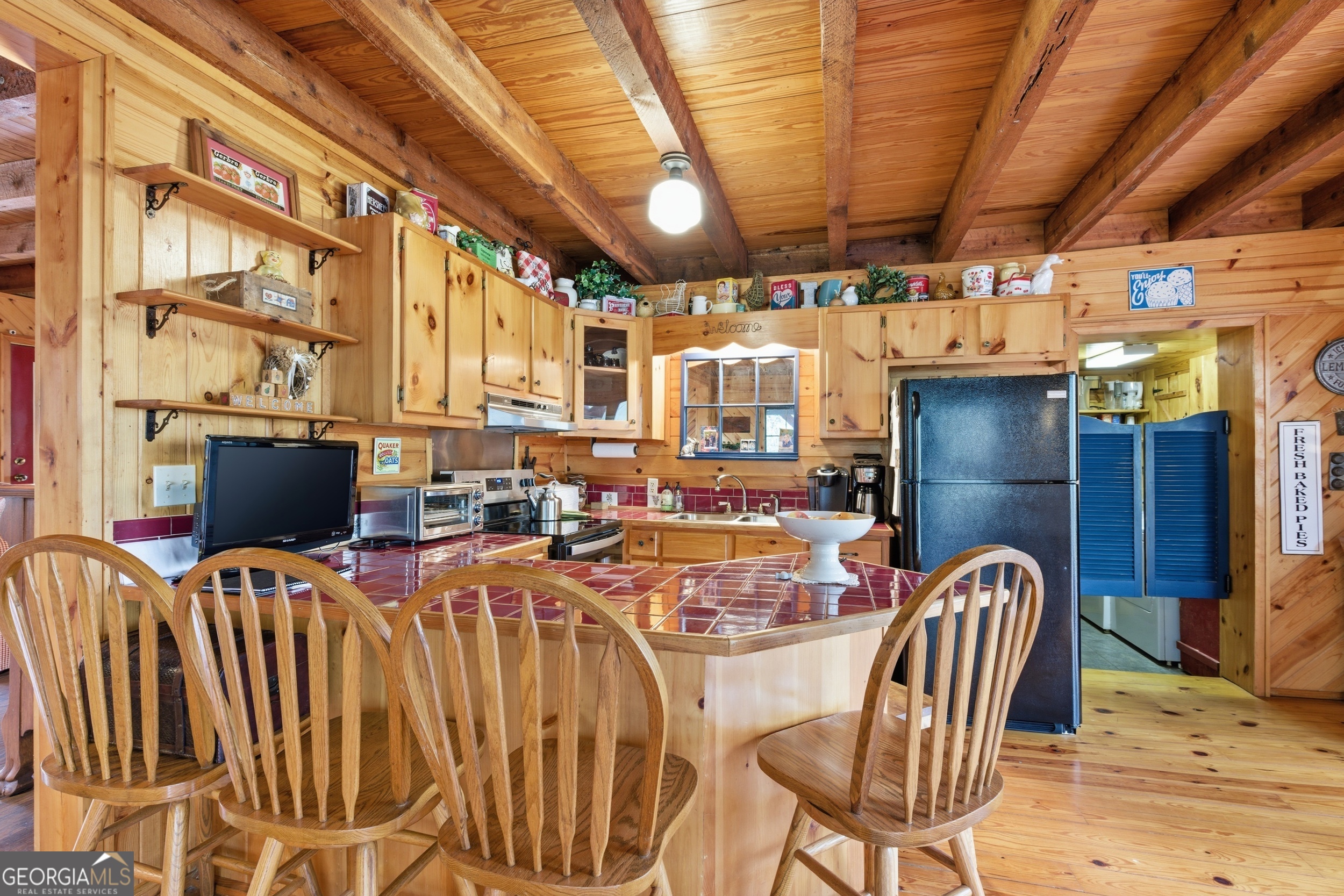 801 Sillycook Trail Clarkesville, GA 30523 - Photo 17 of 47 a view of a dining room with furniture a kitchen a chandelier and wooden floor
