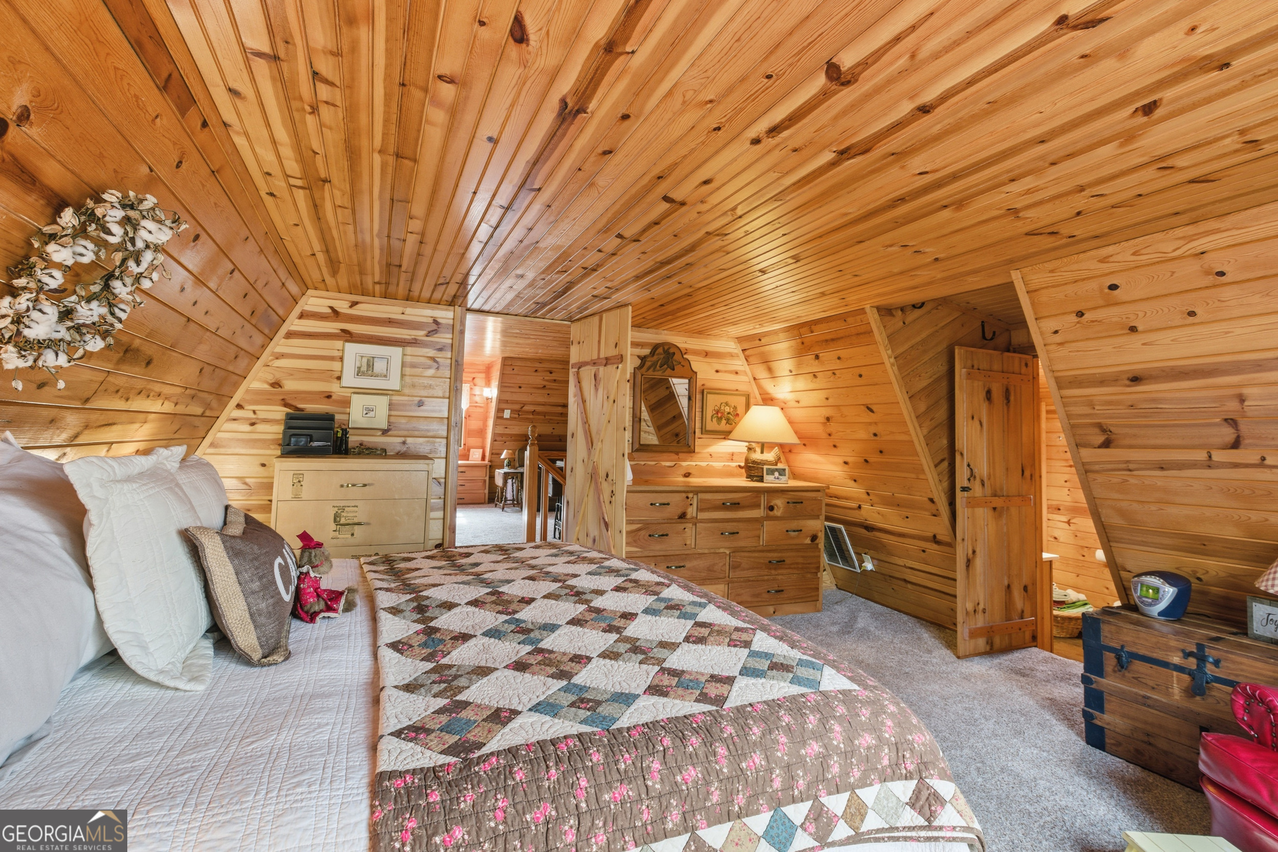801 Sillycook Trail Clarkesville, GA 30523 - Photo 26 of 47 a bedroom with a bed and wooden cabinets
