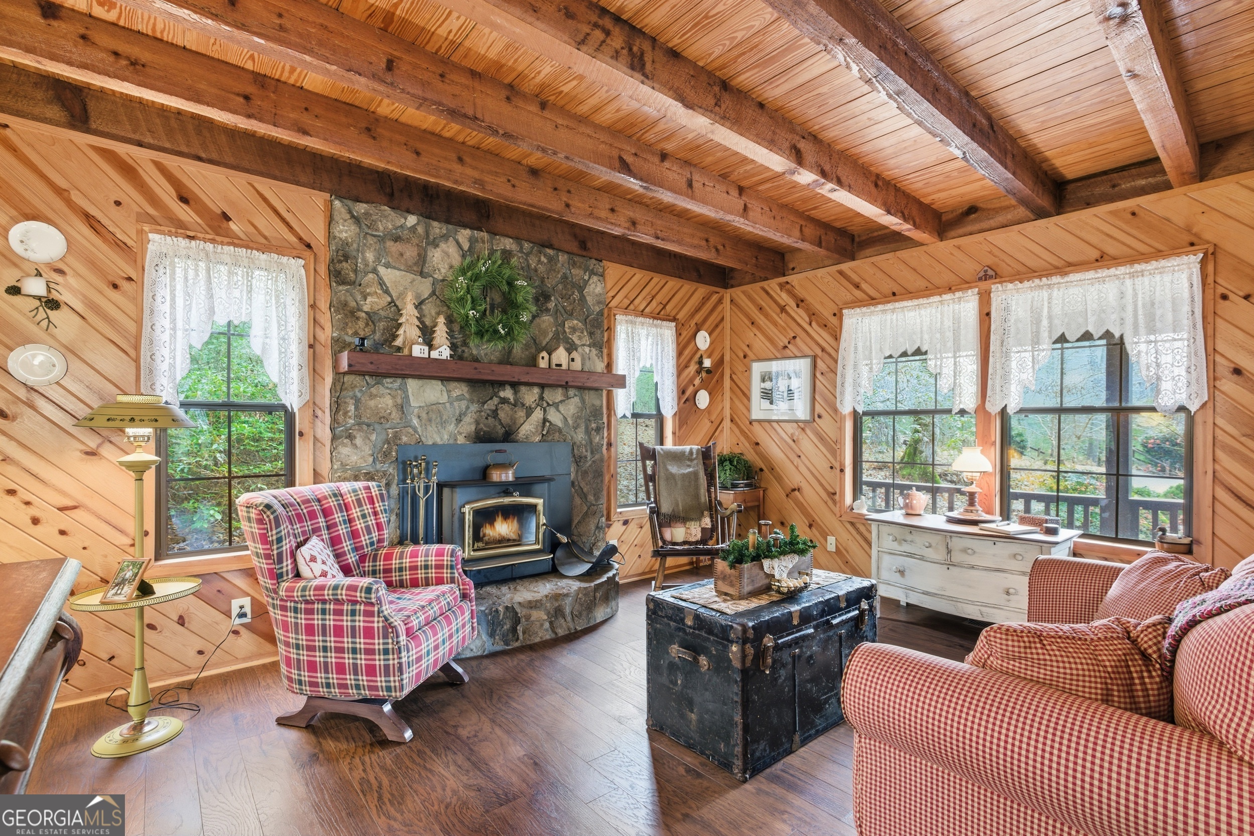 801 Sillycook Trail Clarkesville, GA 30523 - Photo 7 of 47 a living room with furniture a fireplace and a floor to ceiling window