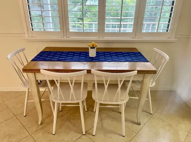 a bath room with a table and windows