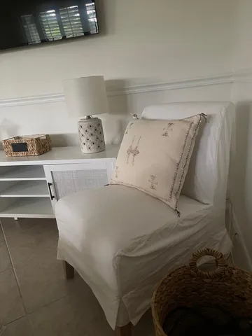 a bed with white sheets and pillows on it