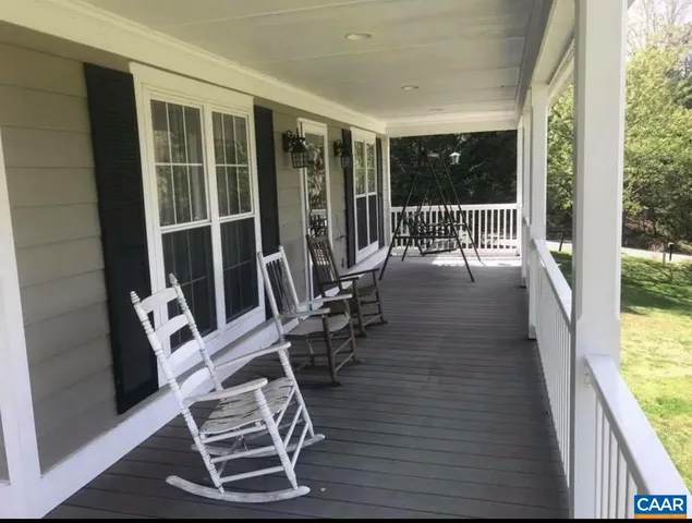 a living room with wooden floor and furniture