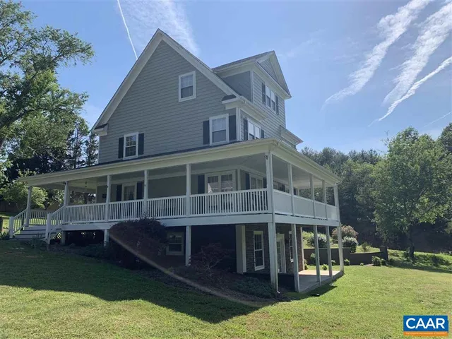 a view of house with yard