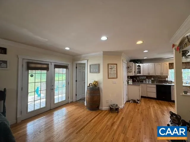 a large space with a large window and wooden floor