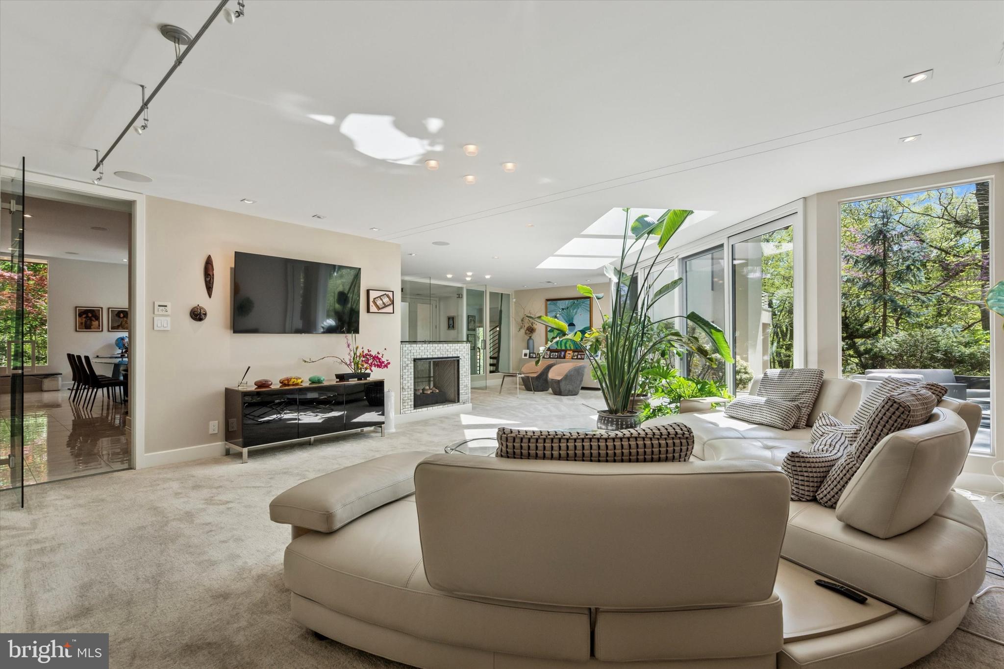 4126 Apalogen Road Philadelphia, PA 19129 - Photo 15 of 75 a living room with furniture a large window and a flat screen tv