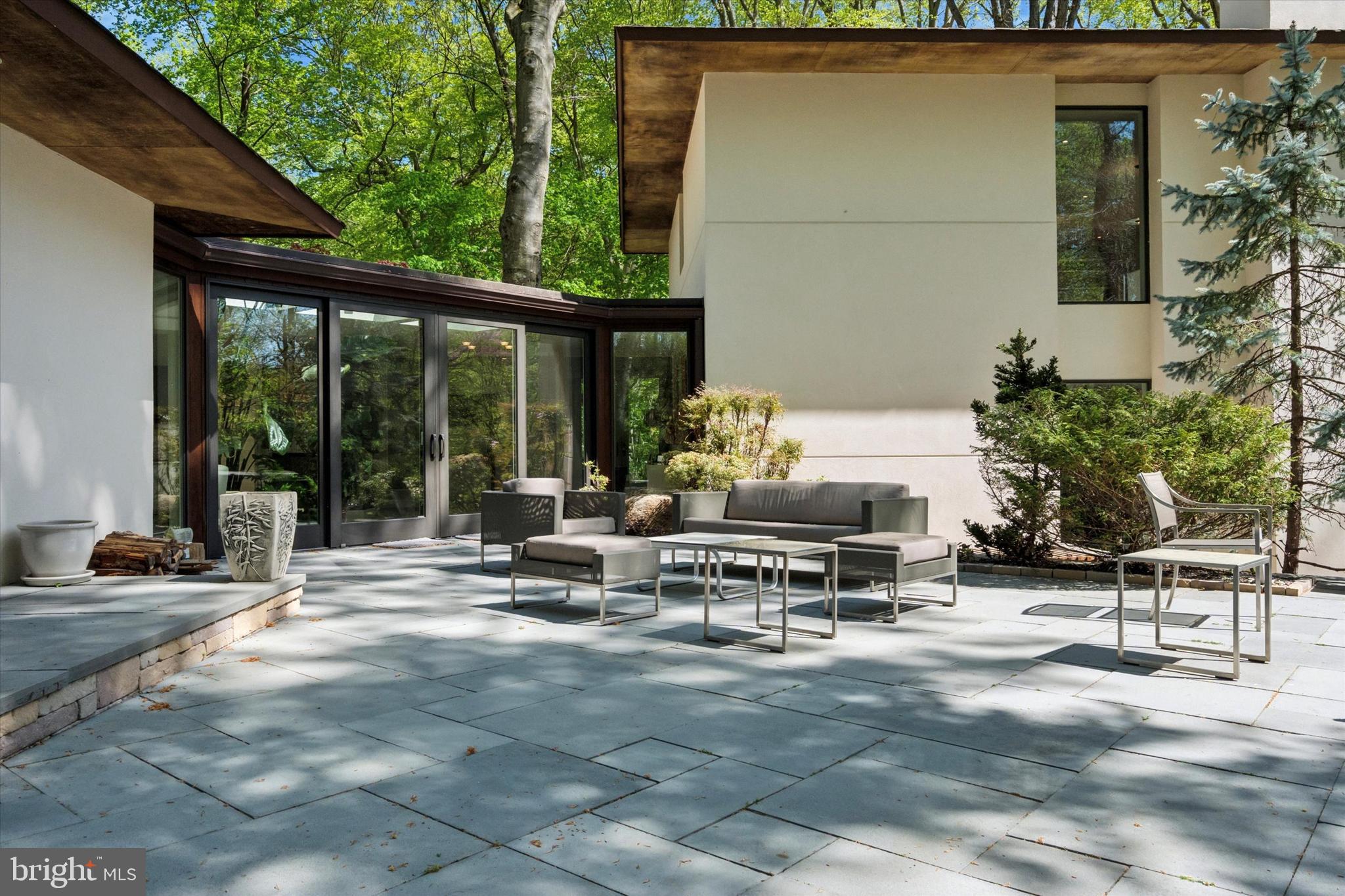 4126 Apalogen Road Philadelphia, PA 19129 - Photo 17 of 75 a view of a patio with table and chairs and potted plants