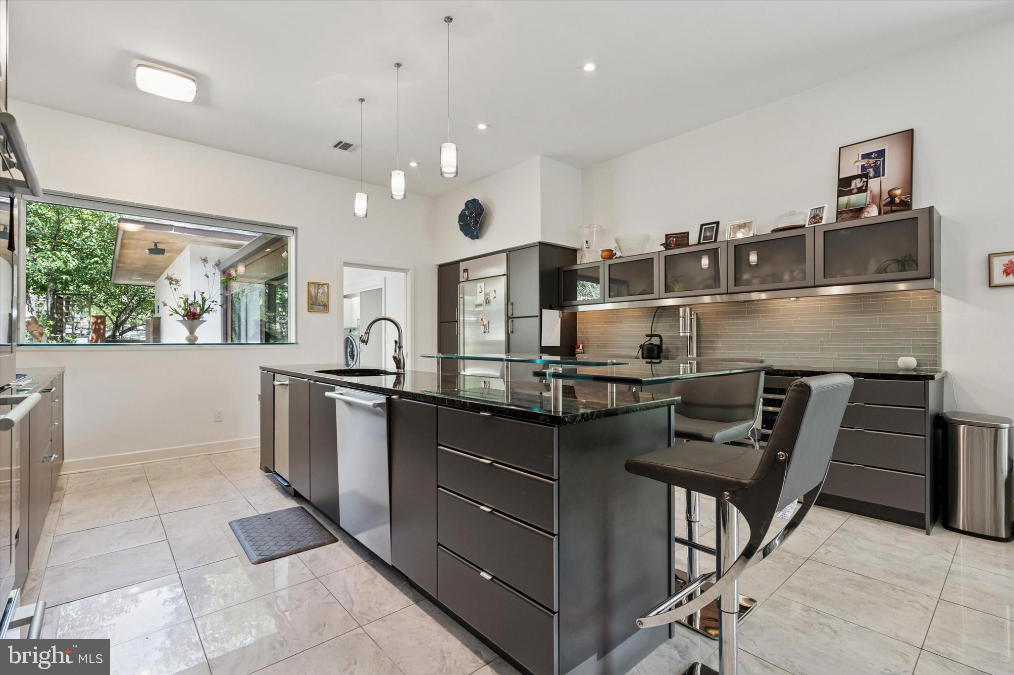 4126 Apalogen Road Philadelphia, PA 19129 - Photo 50 of 75 a kitchen with stainless steel appliances granite countertop a sink and stove
