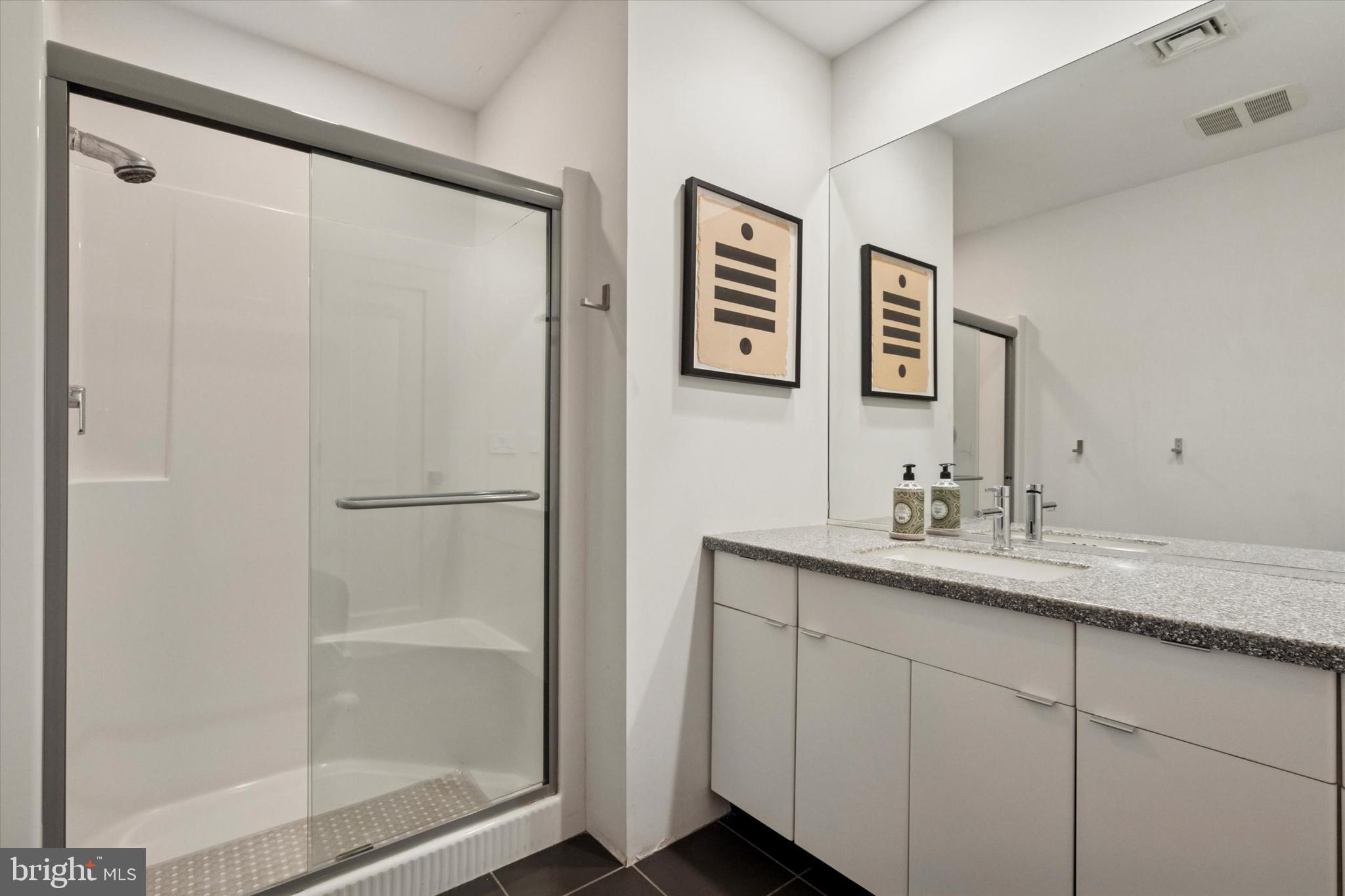 4126 Apalogen Road Philadelphia, PA 19129 - Photo 69 of 75 a bathroom with a shower sink and mirror