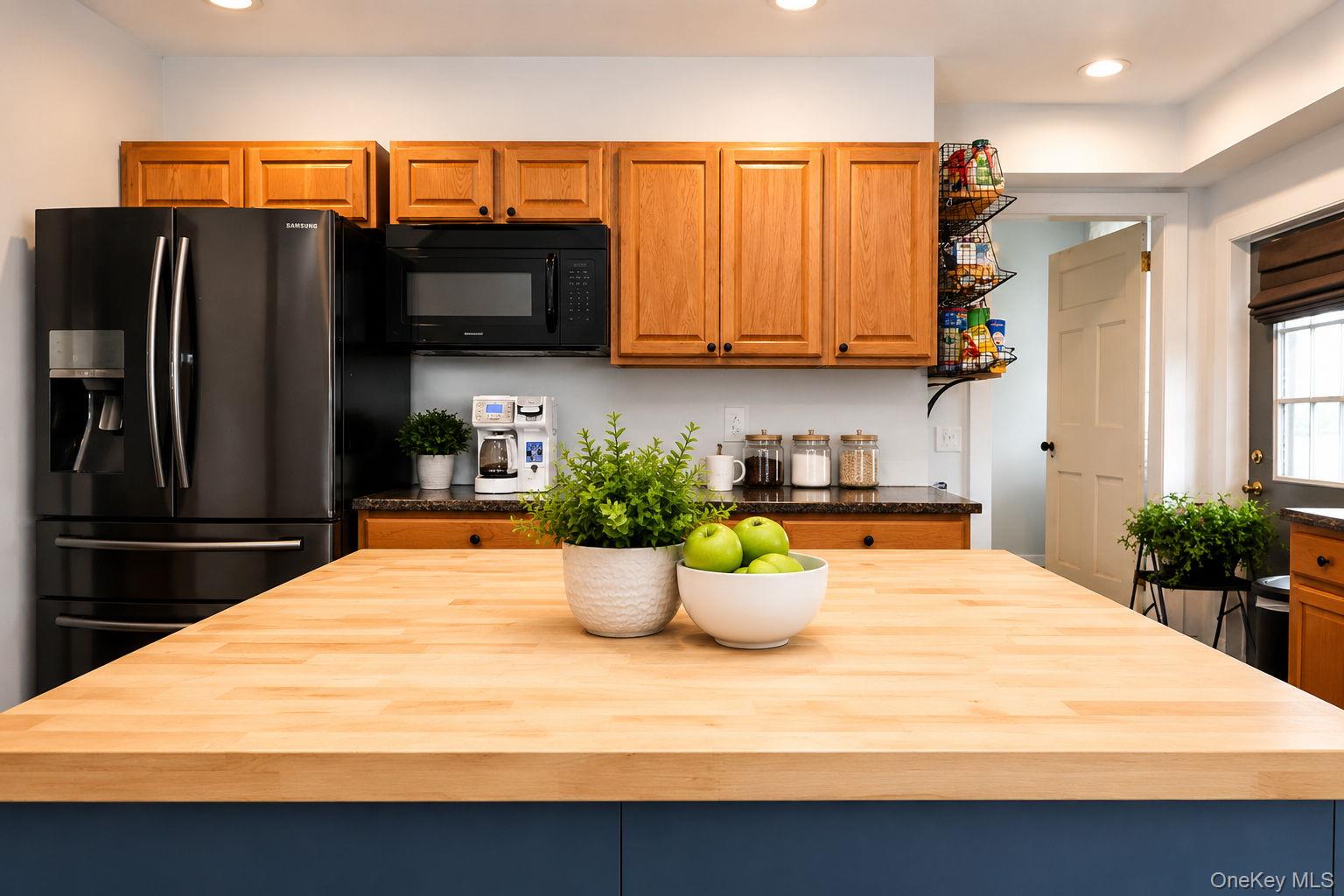 340 Dunn Road Montgomery, NY 12549 - Photo 11 of 34 Black stainless steel double door refrigerator, microwave and wood cabinets