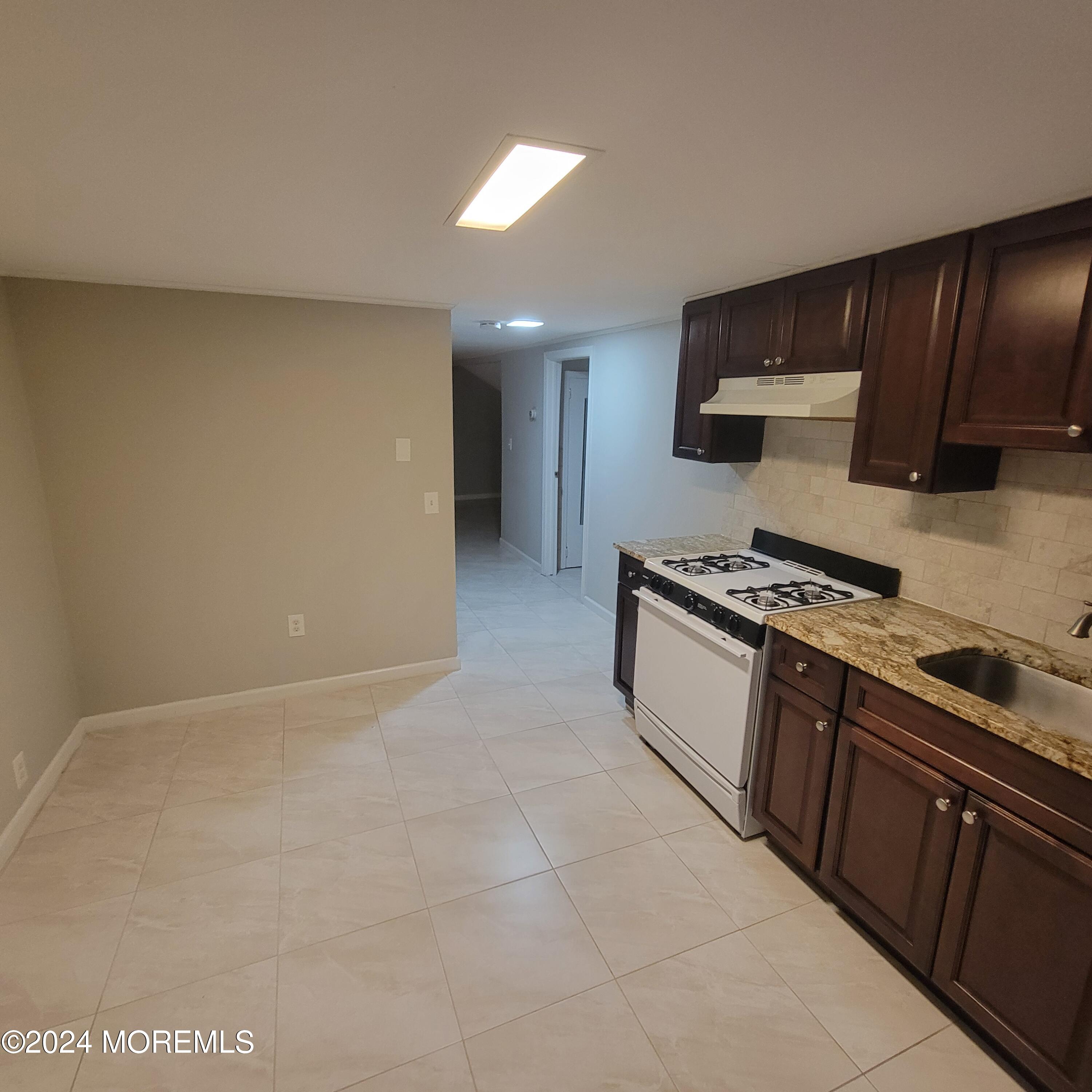 38 Main Street, Unit #5 Keyport, NJ 07735 - Photo 3 of 15 a kitchen with granite countertop a stove and cabinets
