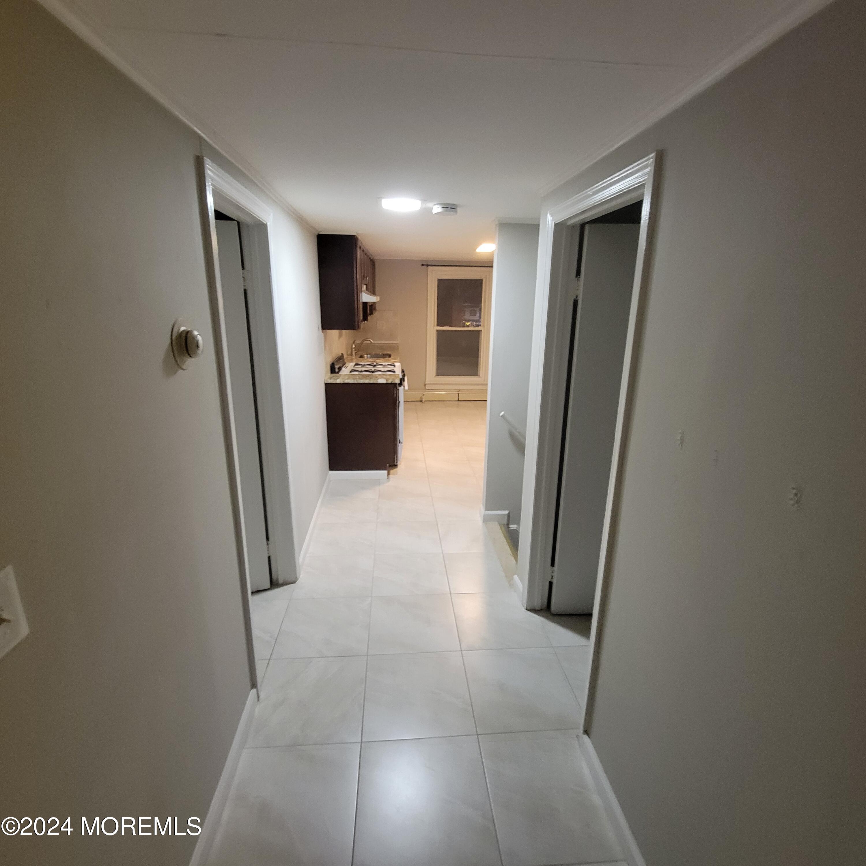 38 Main Street, Unit #5 Keyport, NJ 07735 - Photo 5 of 15 a view of a hallway with a refrigerator