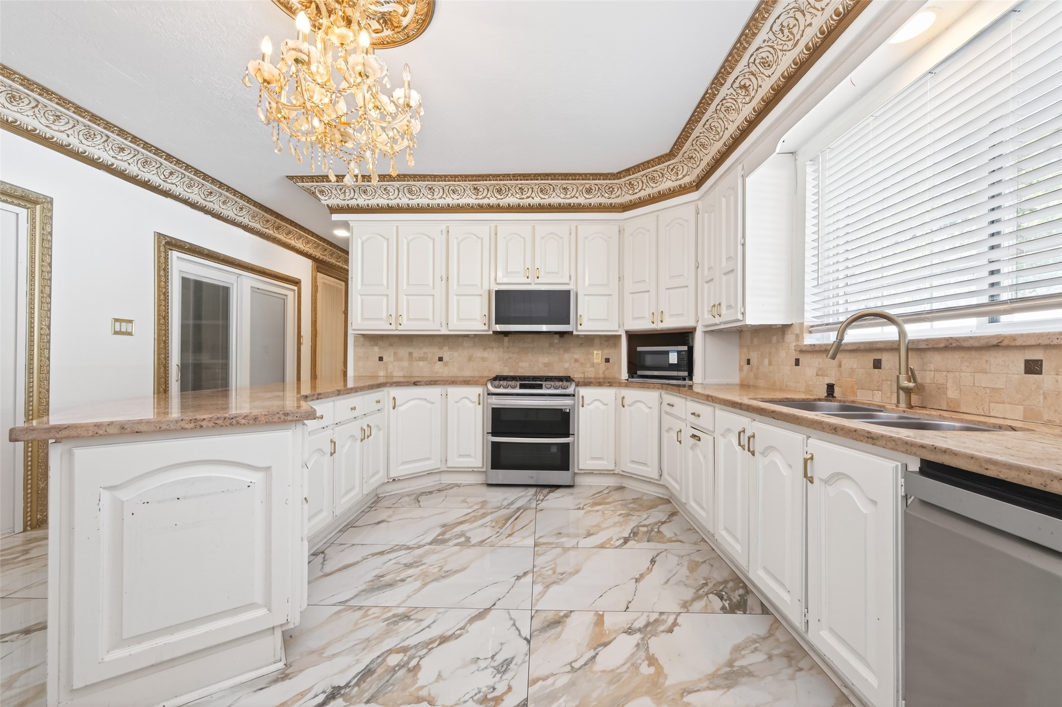 24 Windermere Lane Houston, TX 77063 - Photo 11 of 49 a kitchen with granite countertop a sink stainless steel appliances a window and cabinets