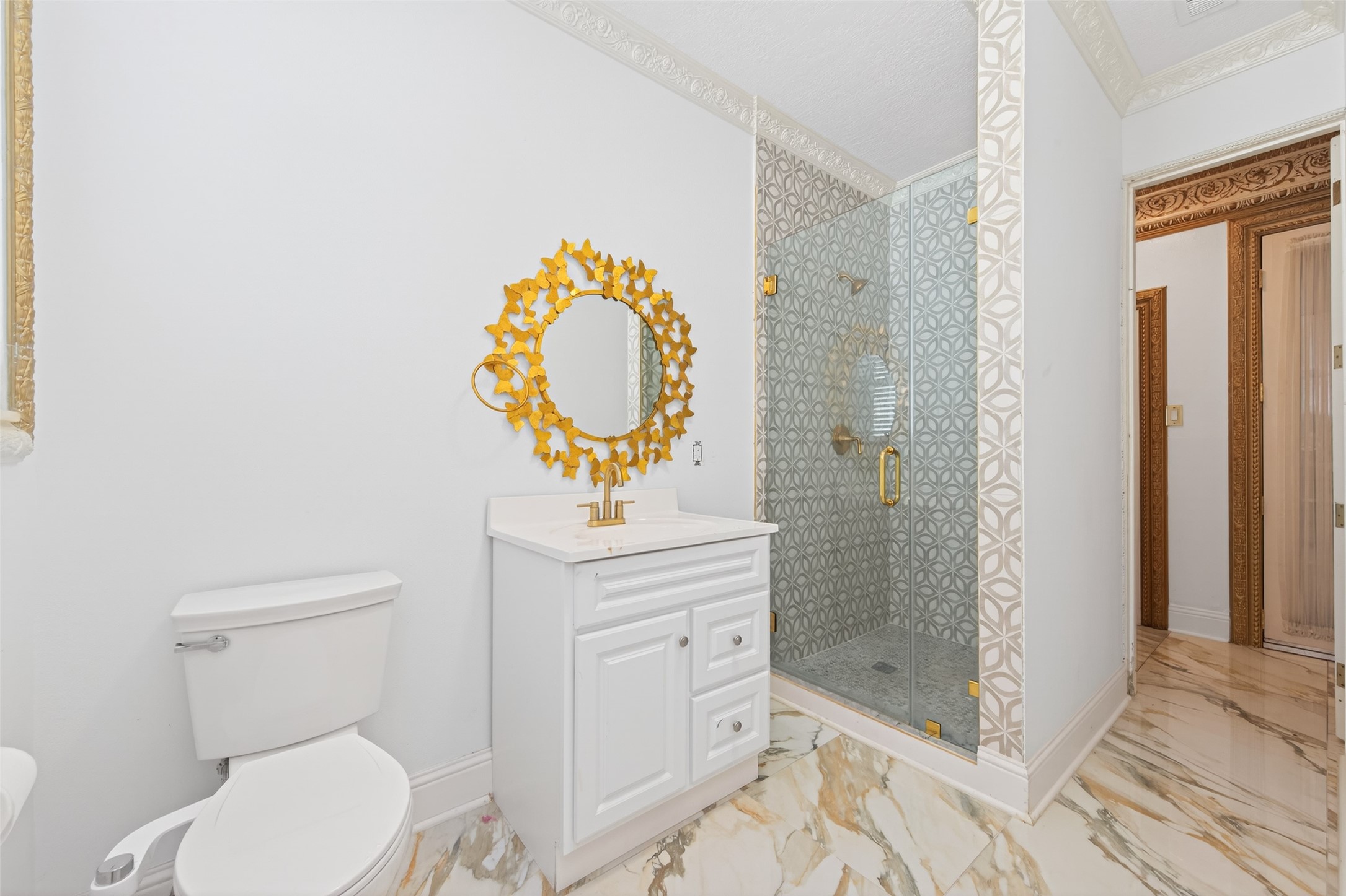 24 Windermere Lane Houston, TX 77063 - Photo 14 of 49 a bathroom with a toilet a sink and glass door