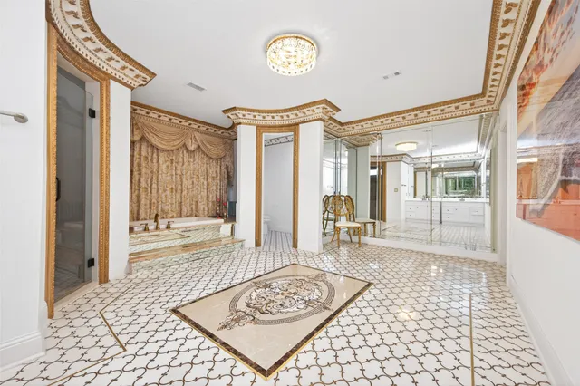 a view of a hallway with wooden floor and a livingroom
