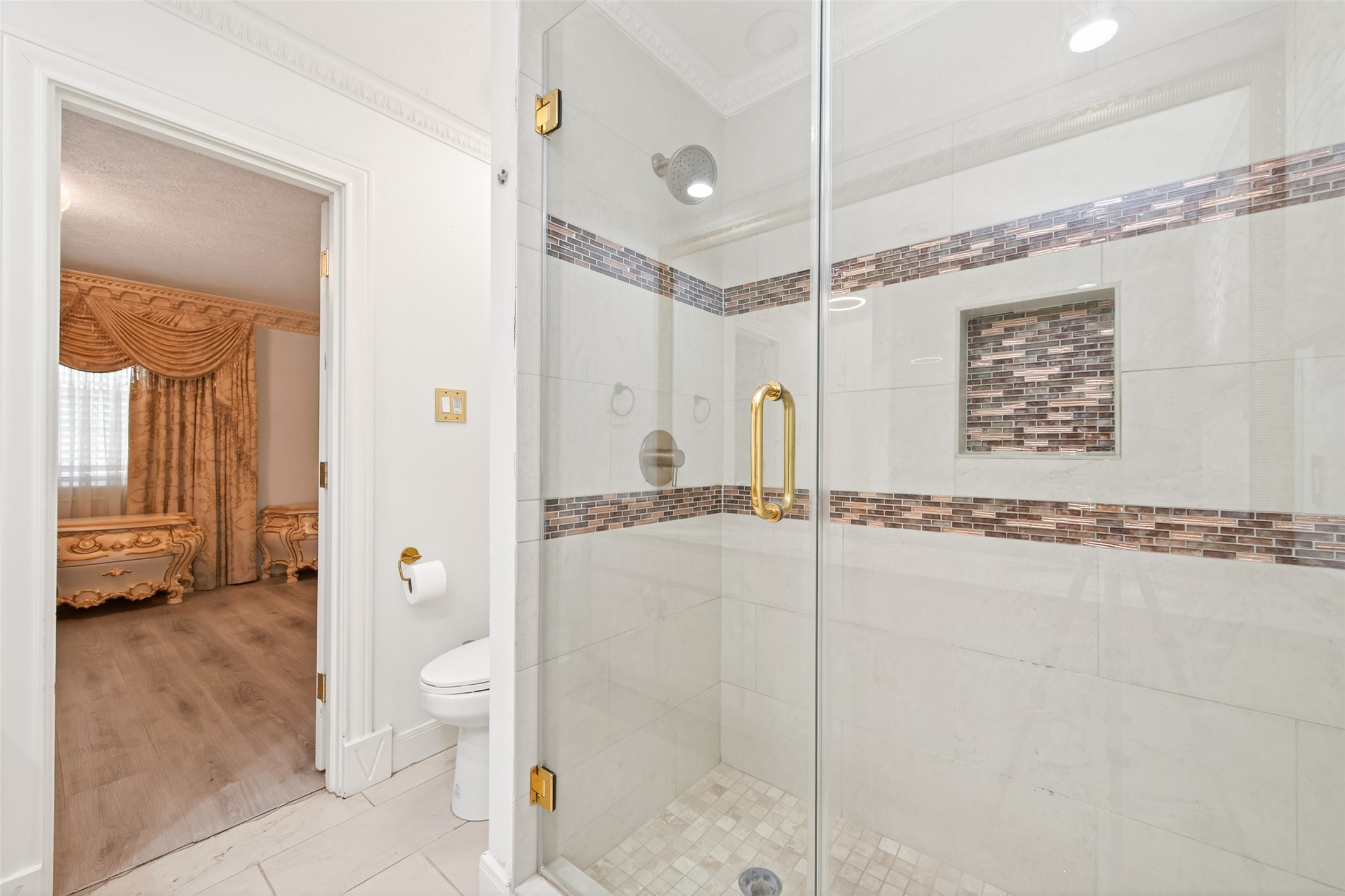 24 Windermere Lane Houston, TX 77063 - Photo 41 of 49 a bathroom with a shower a mirror and a sink