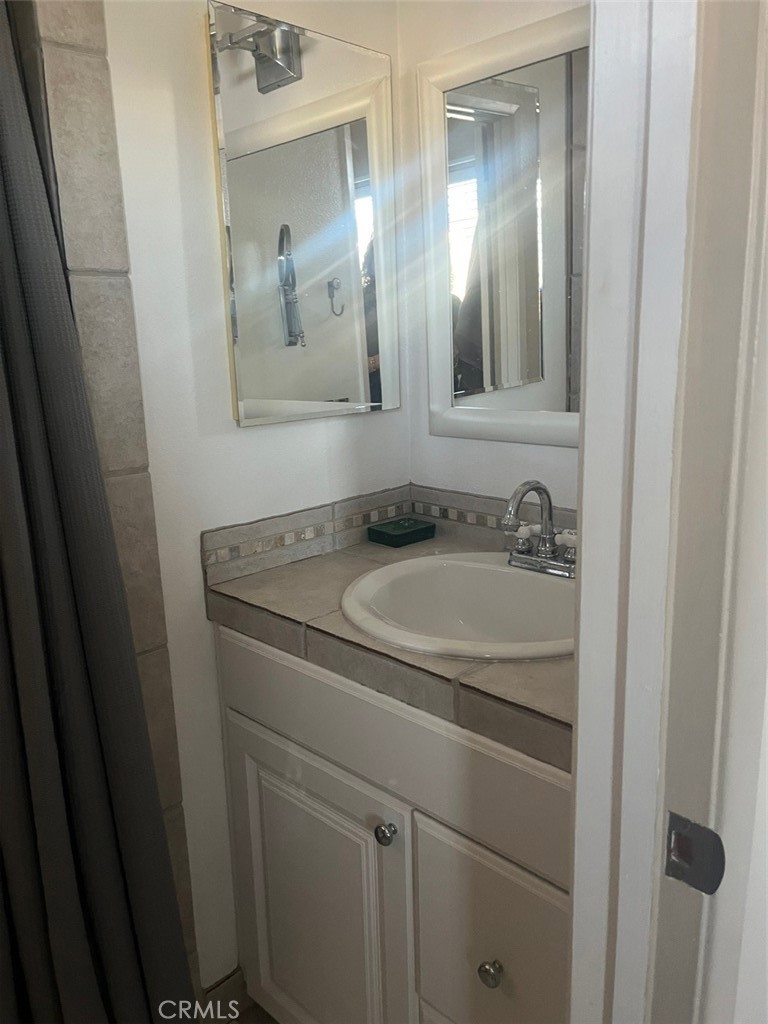 191 C. Mayor Redondo Beach, CA 90277 - Photo 17 of 20 a bathroom with a sink and mirror
