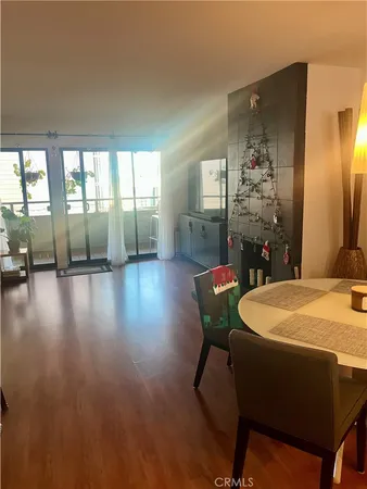 a dining room with furniture and wooden floor
