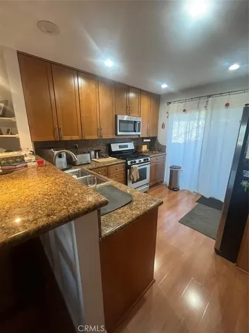 a kitchen with a stove a sink and a microwave