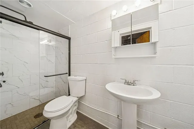 a kitchen with stainless steel appliances granite countertop a sink and a refrigerator